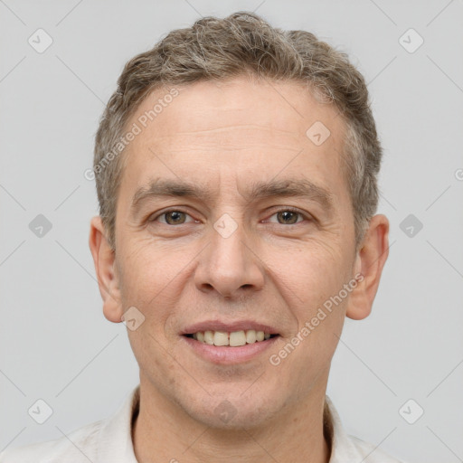 Joyful white adult male with short  brown hair and brown eyes