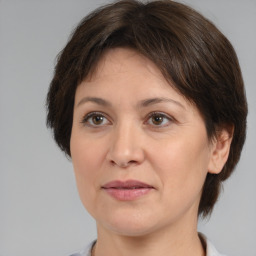 Joyful white adult female with medium  brown hair and brown eyes