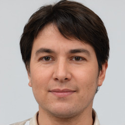 Joyful white adult male with short  brown hair and brown eyes