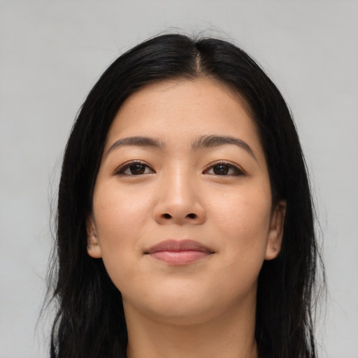 Joyful asian young-adult female with long  black hair and brown eyes