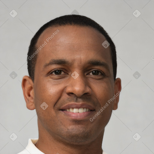 Joyful latino young-adult male with short  brown hair and brown eyes