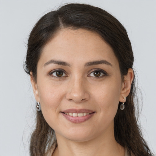 Joyful white young-adult female with long  brown hair and brown eyes