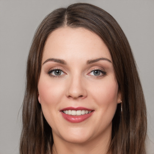 Joyful white young-adult female with long  brown hair and grey eyes