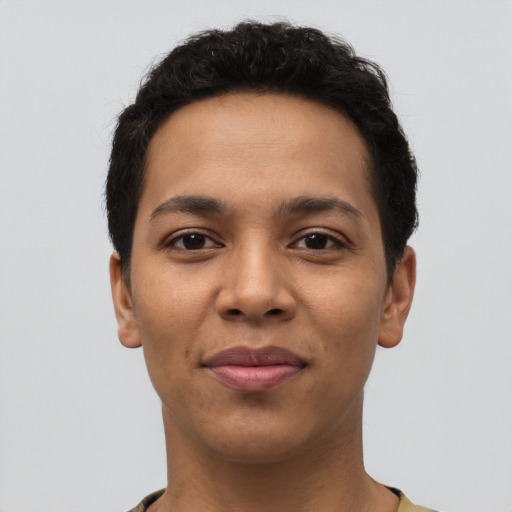 Joyful latino young-adult male with short  brown hair and brown eyes