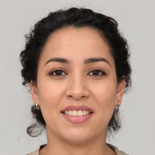 Joyful white young-adult female with medium  black hair and brown eyes