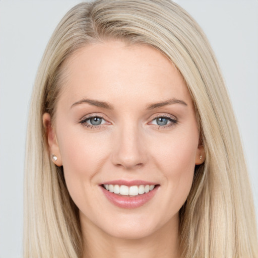 Joyful white young-adult female with long  brown hair and blue eyes