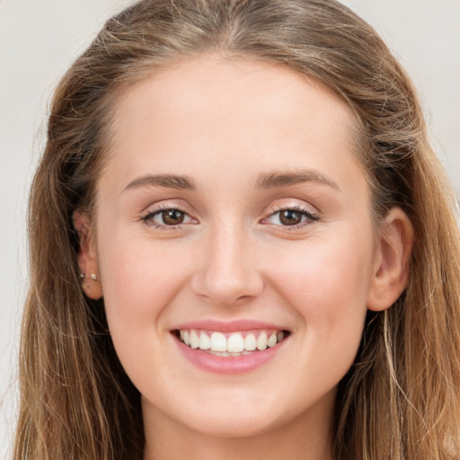 Joyful white young-adult female with long  brown hair and green eyes