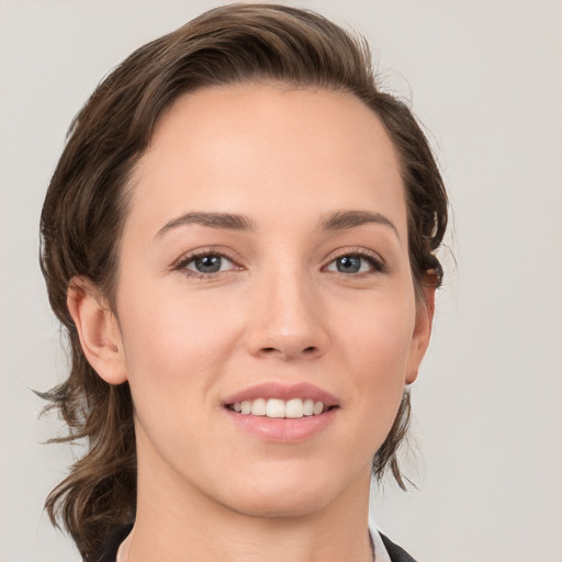 Joyful white young-adult female with medium  brown hair and grey eyes