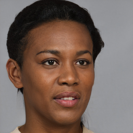 Joyful black young-adult female with short  brown hair and brown eyes
