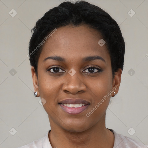 Joyful black young-adult female with short  black hair and brown eyes