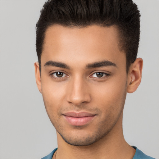 Joyful latino young-adult male with short  brown hair and brown eyes