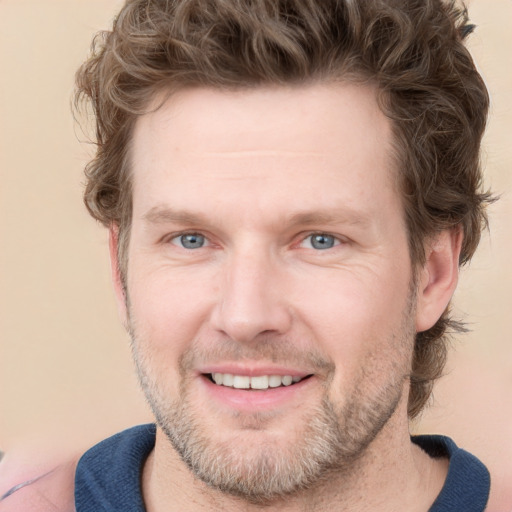 Joyful white adult male with short  brown hair and grey eyes