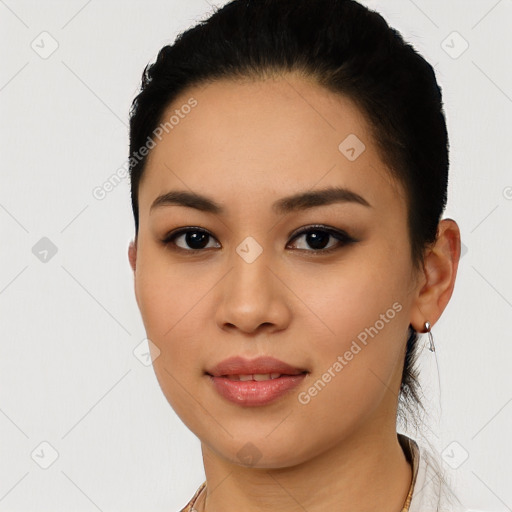 Joyful latino young-adult female with short  black hair and brown eyes