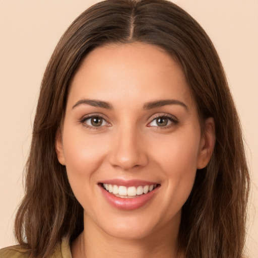 Joyful white young-adult female with long  brown hair and brown eyes