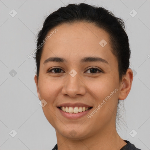 Joyful latino young-adult female with short  brown hair and brown eyes