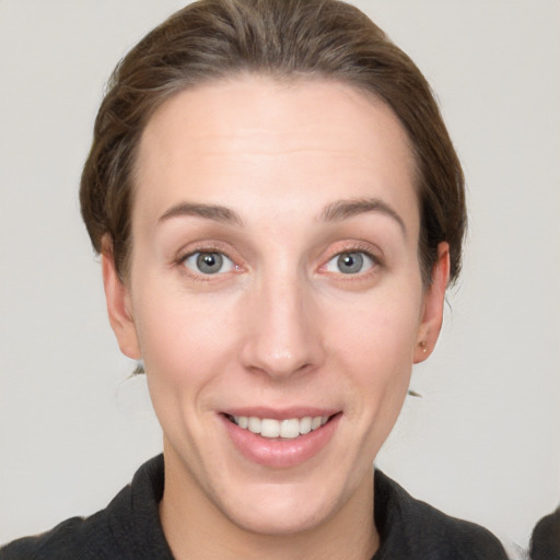 Joyful white young-adult female with short  brown hair and grey eyes