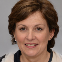 Joyful white adult female with medium  brown hair and brown eyes
