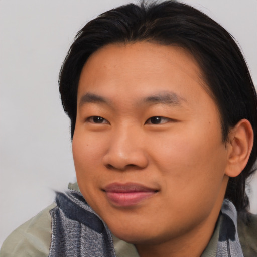 Joyful asian young-adult male with short  brown hair and brown eyes
