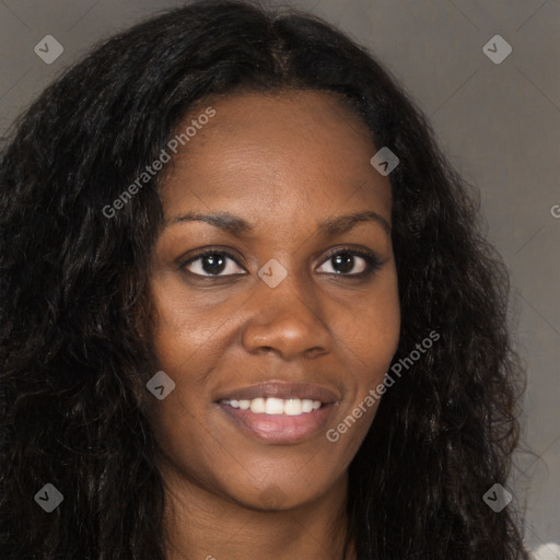 Joyful black young-adult female with long  brown hair and brown eyes