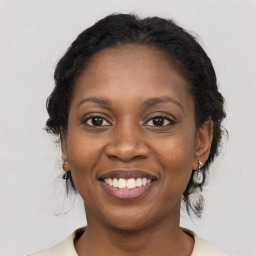 Joyful black young-adult female with medium  black hair and brown eyes
