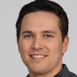 Joyful white young-adult male with short  brown hair and brown eyes