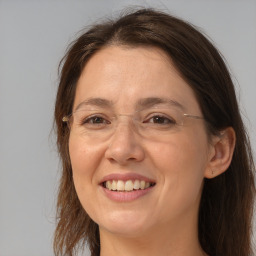 Joyful white adult female with long  brown hair and brown eyes