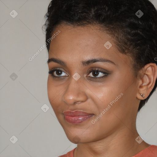 Joyful black young-adult female with short  brown hair and brown eyes