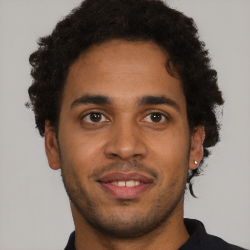Joyful latino young-adult male with short  brown hair and brown eyes