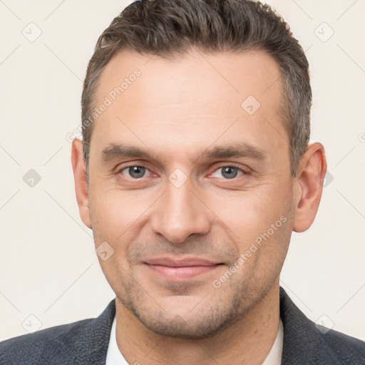 Joyful white adult male with short  brown hair and brown eyes