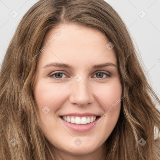 Joyful white young-adult female with long  brown hair and green eyes