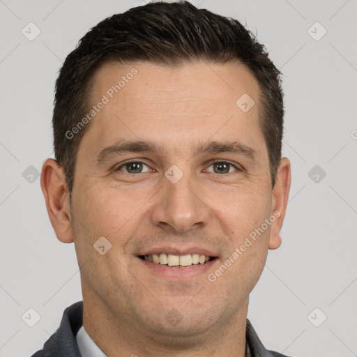 Joyful white adult male with short  brown hair and brown eyes