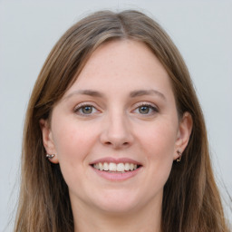 Joyful white young-adult female with long  brown hair and grey eyes