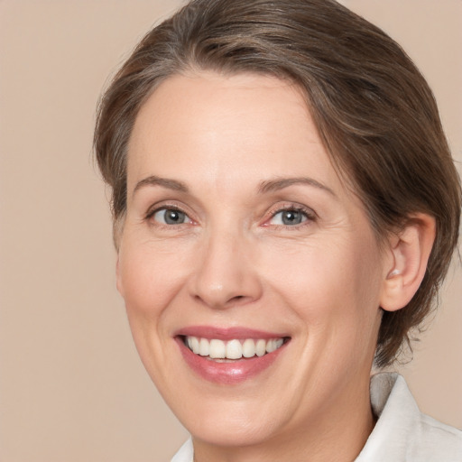 Joyful white adult female with medium  brown hair and brown eyes