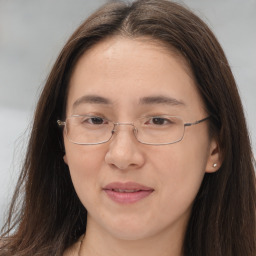 Joyful white adult female with long  brown hair and brown eyes