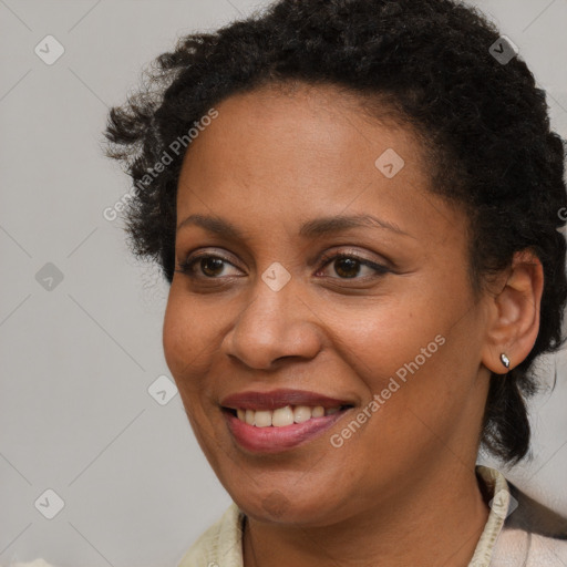 Joyful black young-adult female with short  brown hair and brown eyes