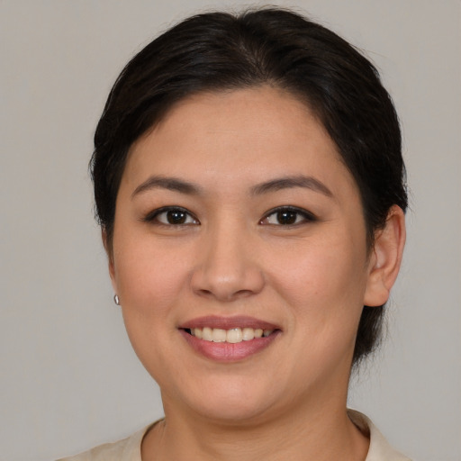 Joyful latino young-adult female with short  brown hair and brown eyes