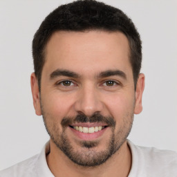 Joyful white young-adult male with short  brown hair and brown eyes