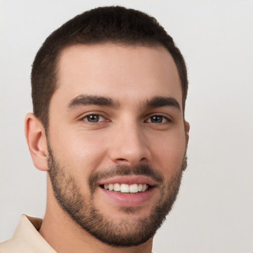 Joyful white young-adult male with short  brown hair and brown eyes