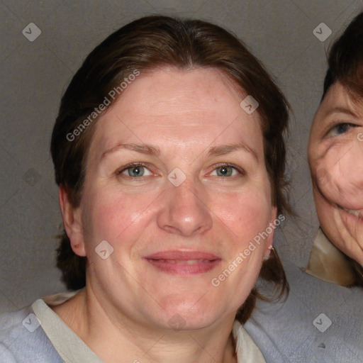 Joyful white adult female with medium  brown hair and blue eyes