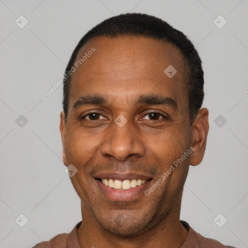 Joyful latino adult male with short  black hair and brown eyes