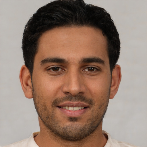 Joyful white young-adult male with short  brown hair and brown eyes