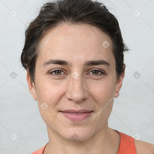 Joyful white adult female with short  brown hair and brown eyes