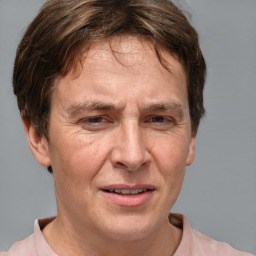 Joyful white middle-aged male with short  brown hair and brown eyes