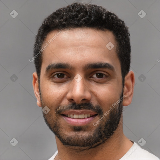 Joyful black young-adult male with short  black hair and brown eyes