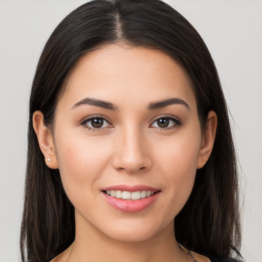 Joyful white young-adult female with long  brown hair and brown eyes