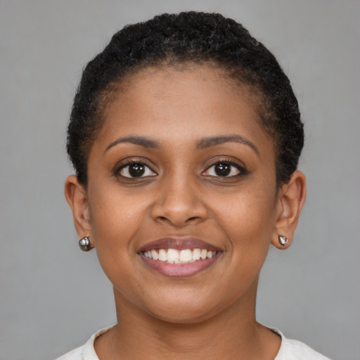 Joyful black young-adult female with short  brown hair and brown eyes