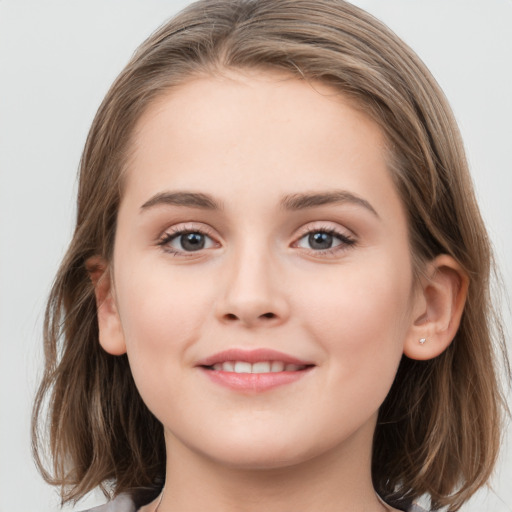 Joyful white child female with long  brown hair and grey eyes