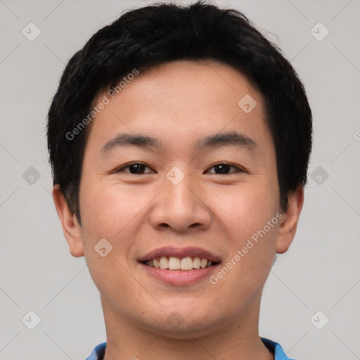 Joyful asian young-adult male with short  black hair and brown eyes