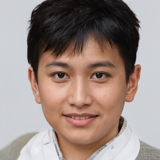 Joyful asian young-adult male with short  brown hair and brown eyes