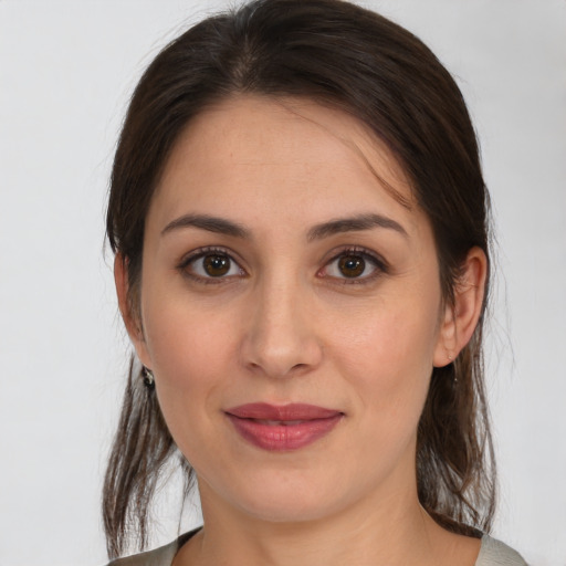 Joyful white young-adult female with medium  brown hair and brown eyes